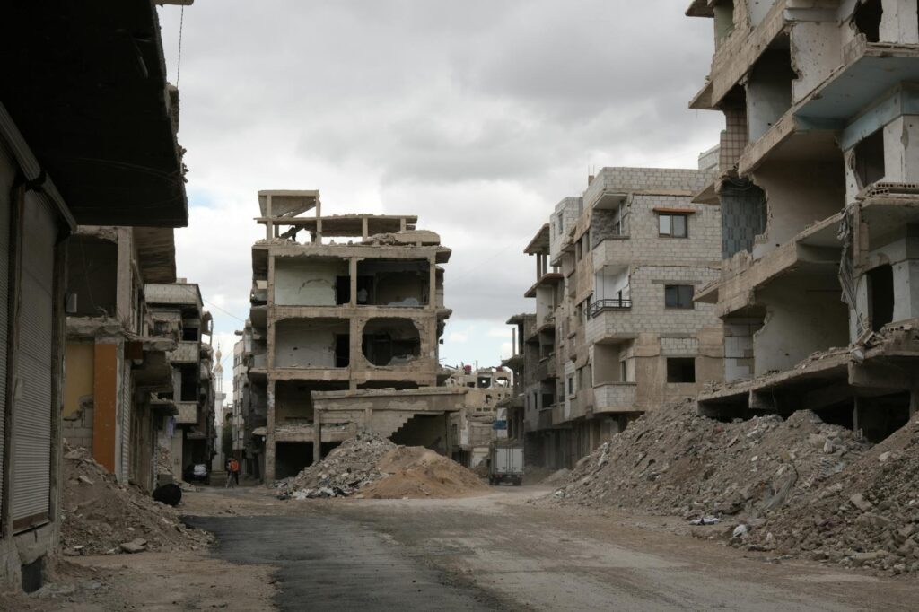 Desolate street with destroyed buildings in Damascus, illustrating war impact.