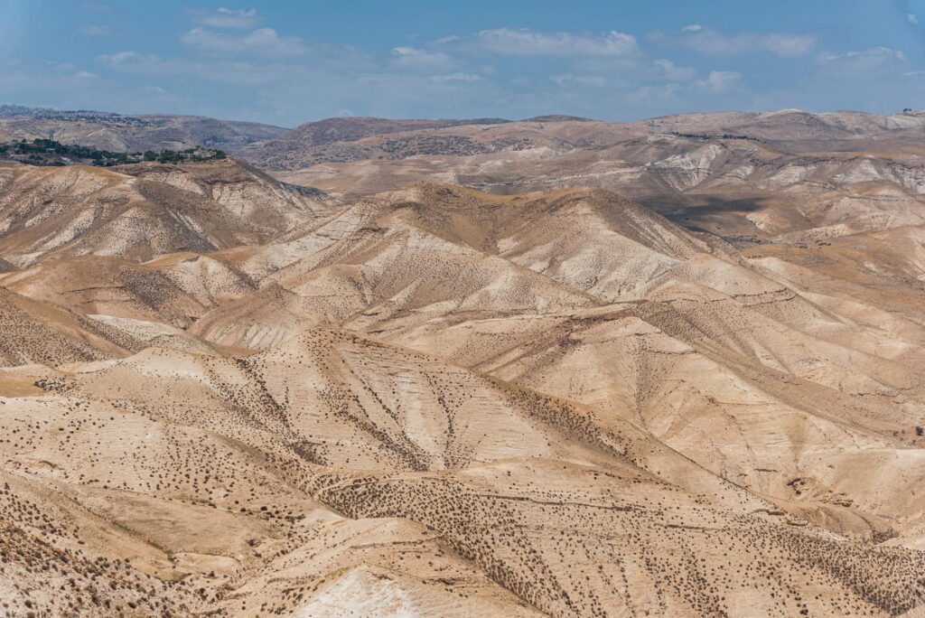 Scenic view of arid desert hills under a clear blue sky in Israel.