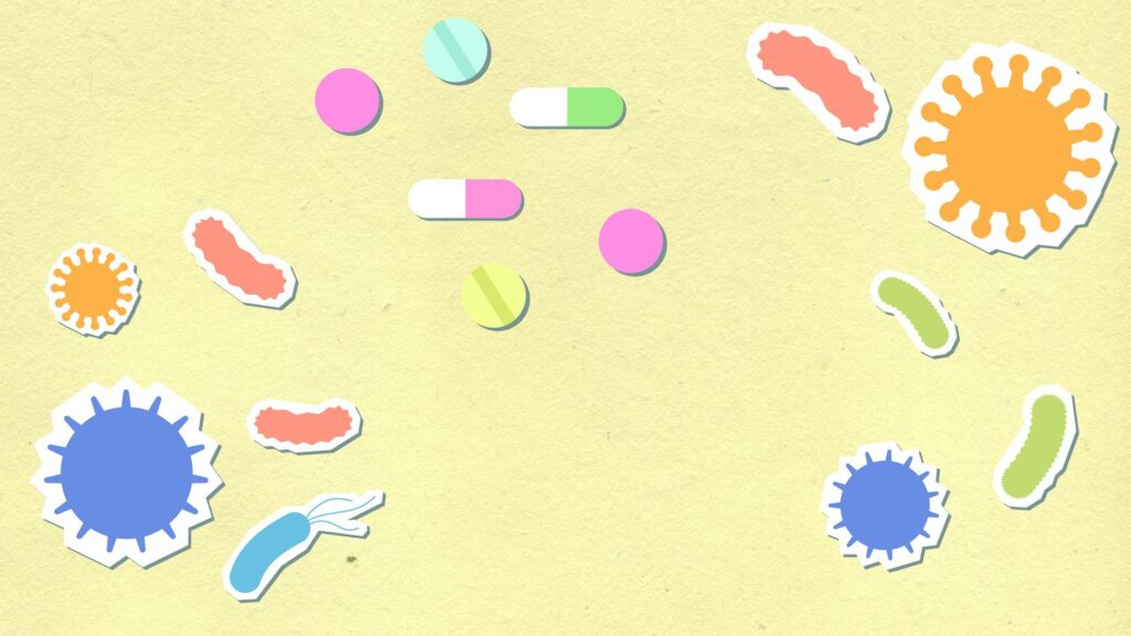 Paper cutout of colorful contagious types of viruses on yellow background with pills and capsules for treatment during disease care routine
