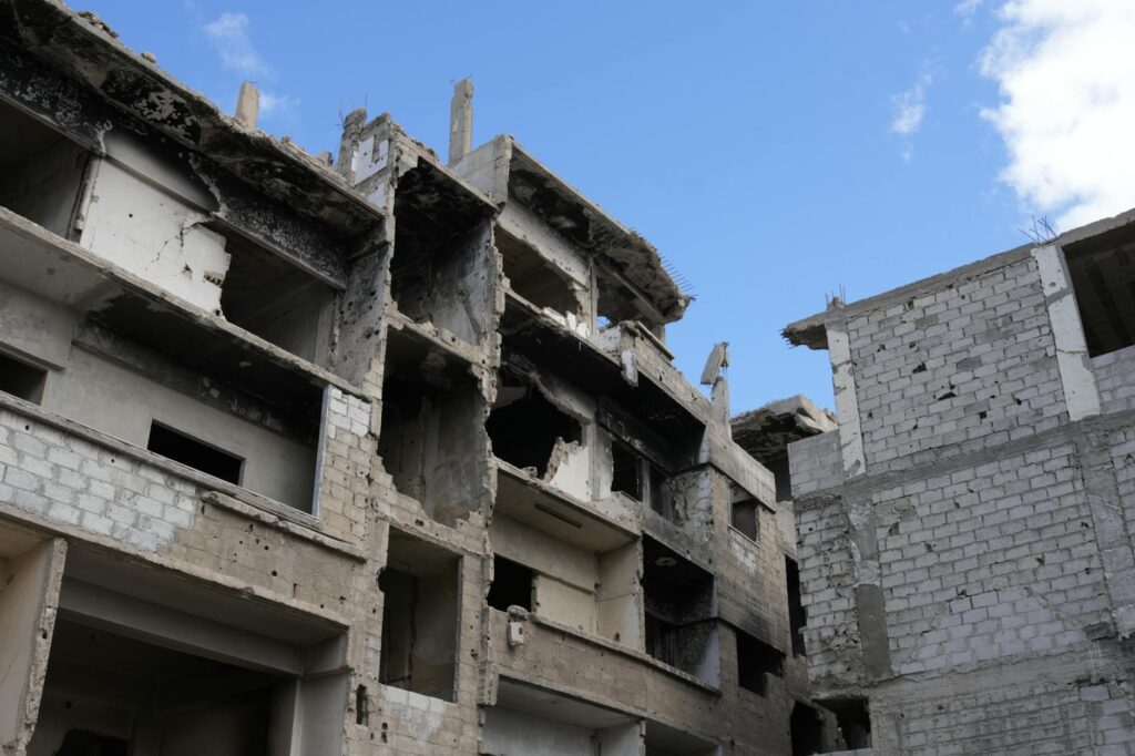 Abandoned and damaged building in Damascus, Syria, showcasing war destruction and urban decay.
