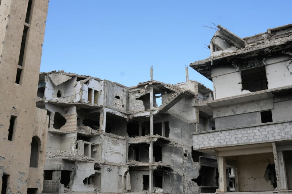 A scene of urban destruction showing damaged buildings in Damascus, Syria.