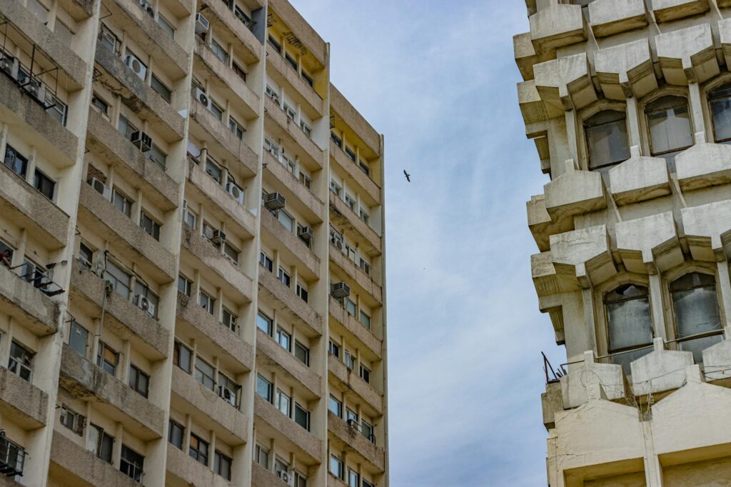 Photo capturing the unique symmetry and brutalist style of New Delhi's high-rise buildings.