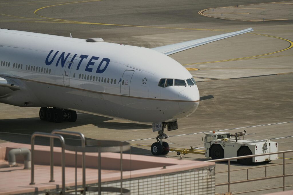 United Airlines aircraft being towed on the runway at Taoyuan City Airport, Taiwan.