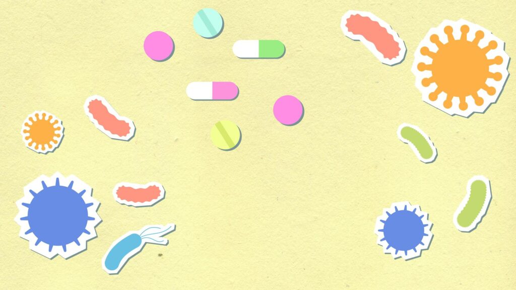 Paper cutout of colorful contagious types of viruses on yellow background with pills and capsules for treatment during disease care routine