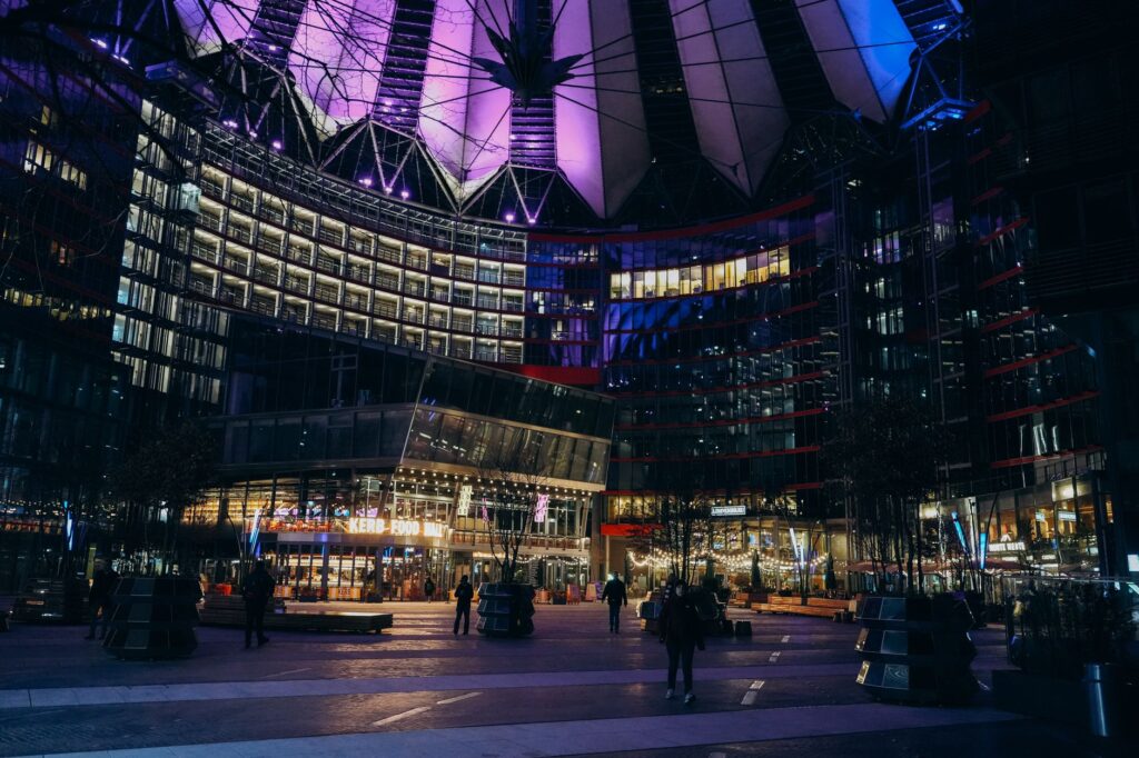 Night view of the Sony Center with vibrant lights and modern architecture in Berlin.