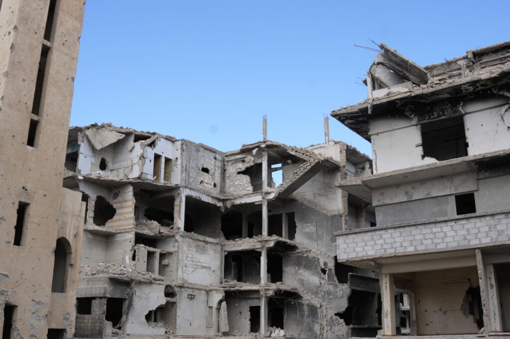 A scene of urban destruction showing damaged buildings in Damascus, Syria.