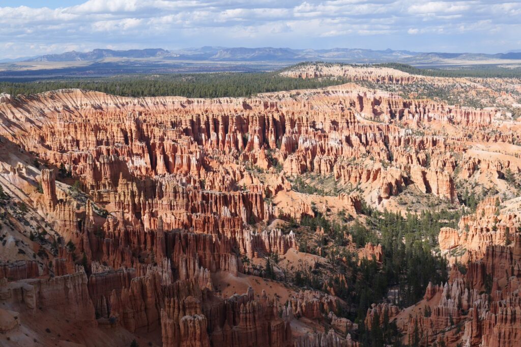 A breathtaking aerial view of Bryce Canyon's iconic hoodoos under a vast sky, showcasing nature's beauty.