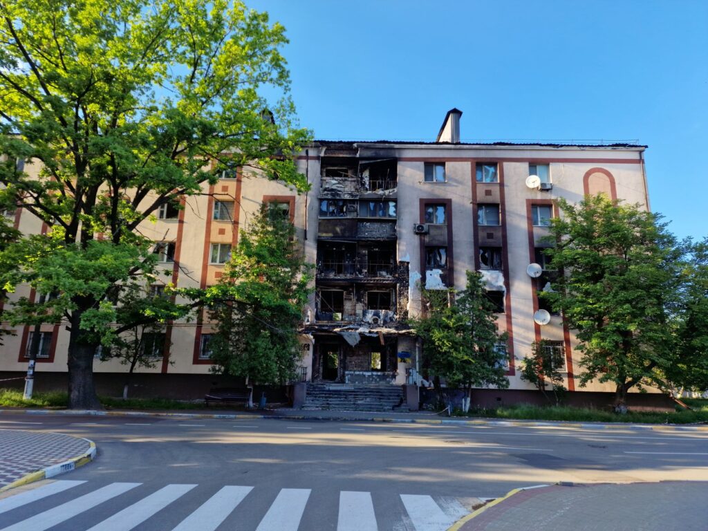 Burnt facade of an apartment building on a city street in Bucha, Ukraine.
