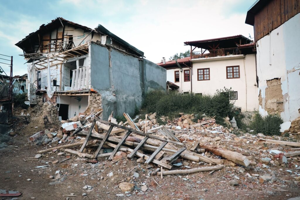 A village destroyed by an earthquake, showcasing damaged buildings and debris.