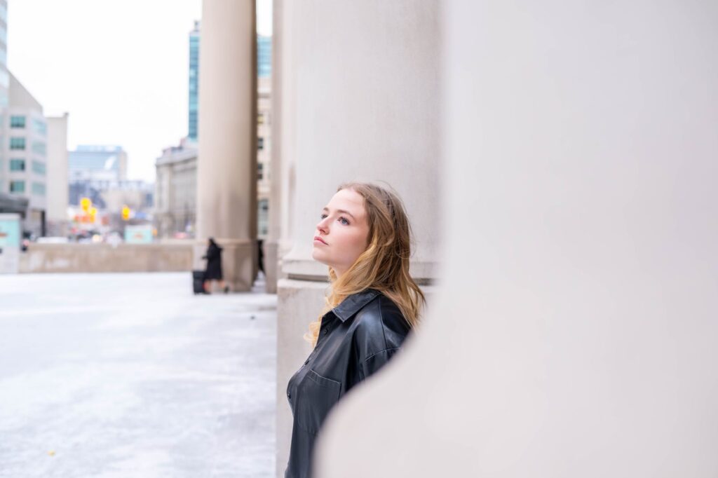 Artistic urban portrait of a woman in Toronto. Stylish and contemplative mood.